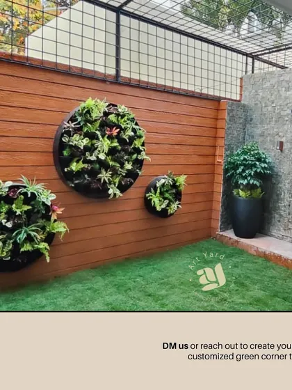 After: The completed circular vertical garden, now a living piece of art on the wall. The round planters are filled with a variety of plants, creating texture and visual interest.
