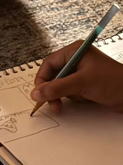 A close-up of a child's nature journal, where they are sketching the different moths they've observed during our night science session.