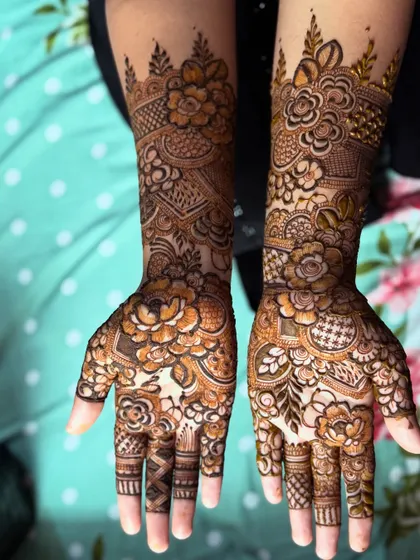A full view of the party floral henna on both hands, showing the symmetrical and festive design.