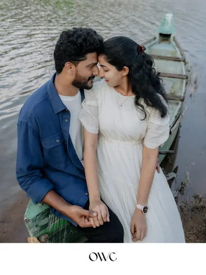 A close-up of a couple holding hands and touching foreheads on a boat, a perfect picture of love and serenity.