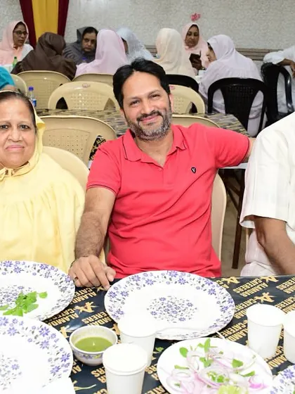 A happy family posing for a photo at their table.
