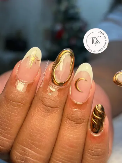 A close-up of the celestial-themed 3D nail art. This image shows the detail of the sculpted gold frames, a crescent moon charm, and a starburst accent.
