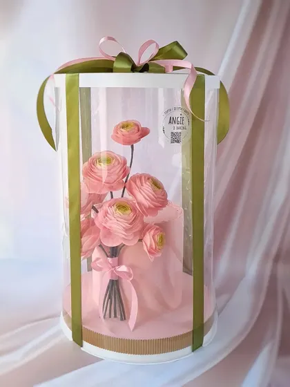 The same floral cake, professionally packaged for delivery. Our business classes cover how to source and use packaging that protects and enhances your creations.