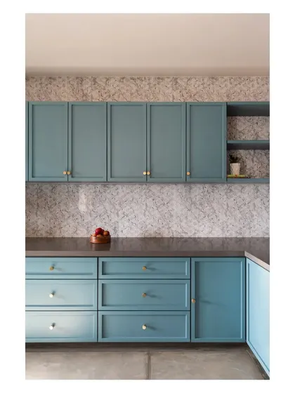 A detail of the 'House of Skye' kitchen, showing the speckled terrazzo backsplash against the custom-painted blue cabinets. Every material is chosen for its unique character and ability to contribute to the overall story of the home.