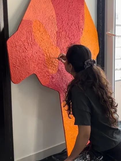 Adding the final touches to a large, textured abstract piece with a vibrant color palette. I get completely lost in the process of creating.