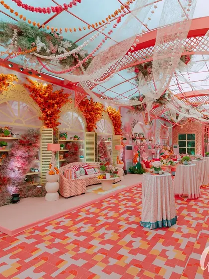 A wide view of the daytime event space, showing the patterned floor, draped ceiling, and distinct seating zones. This demonstrates how we structure a large space to feel both grand and intimate.