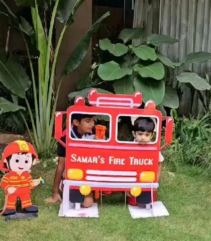 Another photo of the kids enjoying the fire truck prop.