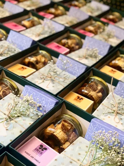 A side view of the wedding invitation hampers, showcasing the depth of the gift box and the variety of items inside.