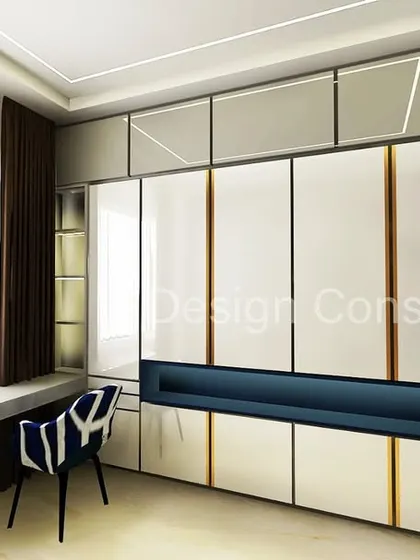 A sleek and modern wardrobe design with a built-in study desk. The white and blue color scheme is fresh and contemporary, and the gold accents on the wardrobe add a touch of luxury.