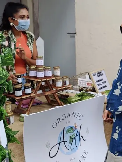 Chatting with a curious customer at my stall. I'm always happy to explain the ingredients and benefits of each product and help you find the perfect match for your skin.