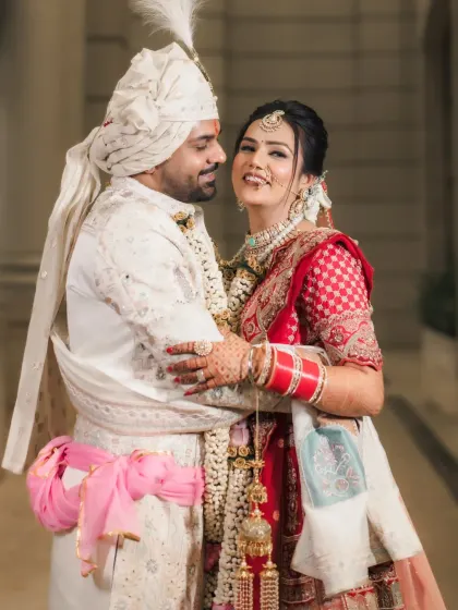 A happy and classic portrait of the bride and groom, showcasing their beautiful wedding outfits.