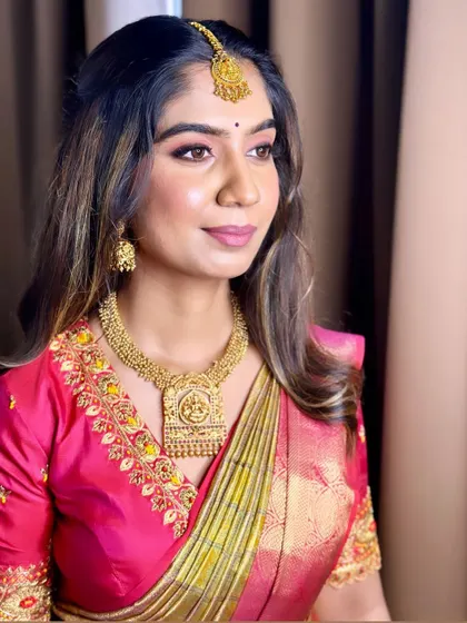 Rachana looking stunning in a traditional pink saree for a family event. The makeup is soft and glowing, with a focus on the eyes.