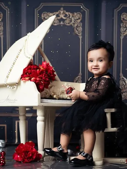 A perfect portrait of a little lady on her first birthday, surrounded by classic and festive decor.