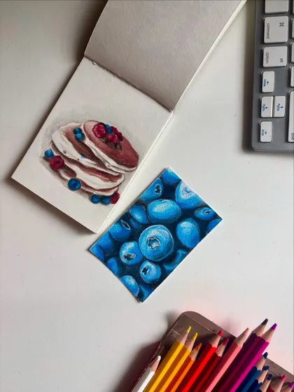 Another view of my color pencil tests, with the pancake sketch and blueberry drawing.