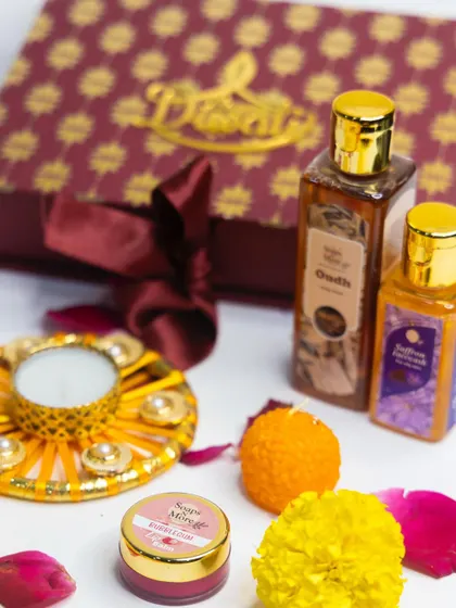 A luxurious Diwali gift set in a deep maroon box. This hamper features our premium Oudh body wash, Saffron face wash, a bubblegum lip balm, a Ladoo candle, and a decorative diya.