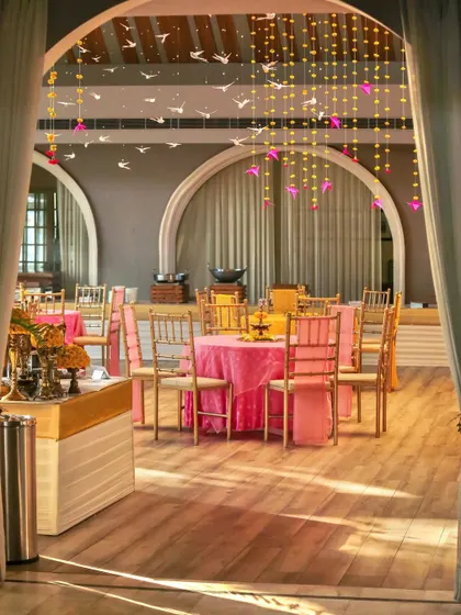Our indoor hall setup for a daytime event, with tables dressed in sunny yellow and soft pink.