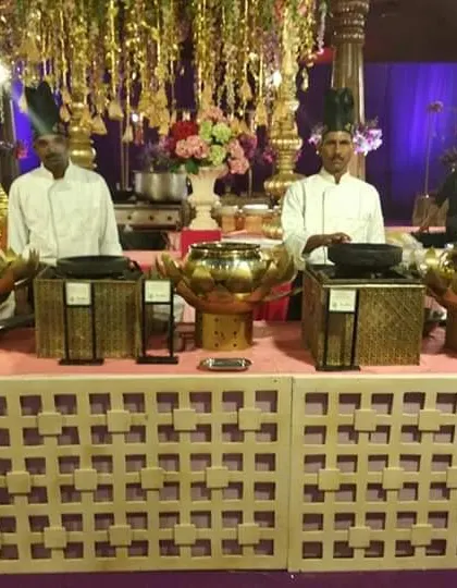A clear shot of the chefs at the traditional live station, showcasing their readiness to provide excellent service at a grand wedding event.