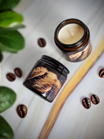 An overhead shot of the 'Warm Hug' candle, surrounded by coffee beans to give you a sense of its deep, aromatic fragrance.