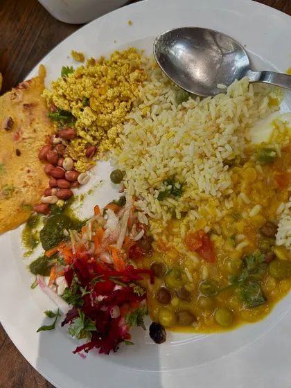 A perfectly balanced plate. This meal includes protein from the dal and scrambled paneer, complex carbs from the rice, and plenty of vitamins from the fresh salad.