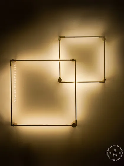 A closer look at our minimalist square LED wall sconces. The slim gold-finished frame emits a soft backlight, creating a halo effect on the wall. These can be arranged in overlapping patterns for a custom art installation.