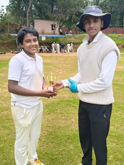 A player receiving a trophy for his performance in the RRCC U-14 Tournament after a thrilling win.