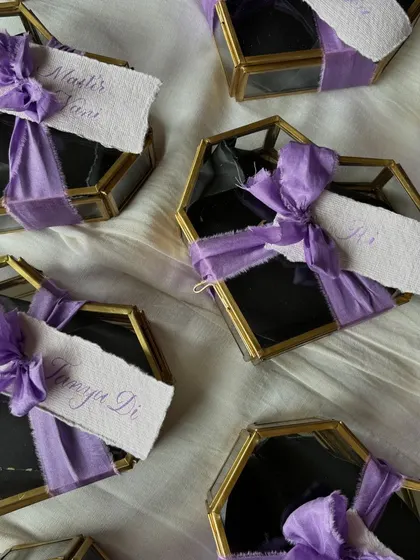I had the pleasure of engraving these stunning heart-shaped glass boxes. Each box was personalized with an initial and a tiny heart, finished with a handwritten name tag and a delicate purple silk ribbon.