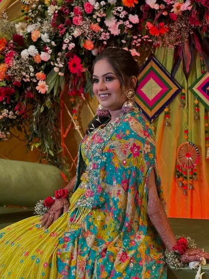 A candid shot from the mehendi ceremony. The vibrant background and her joyful expression perfectly capture the festive spirit.