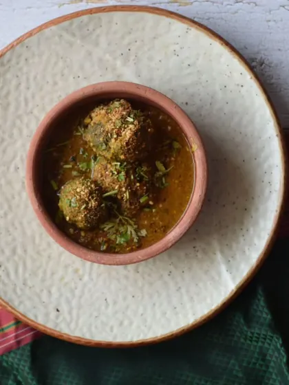 A vegetarian Kolhapuri specialty. These are delicious vegetable balls in a flavourful curry, a highlight from my all-vegetarian home dining experience menu.