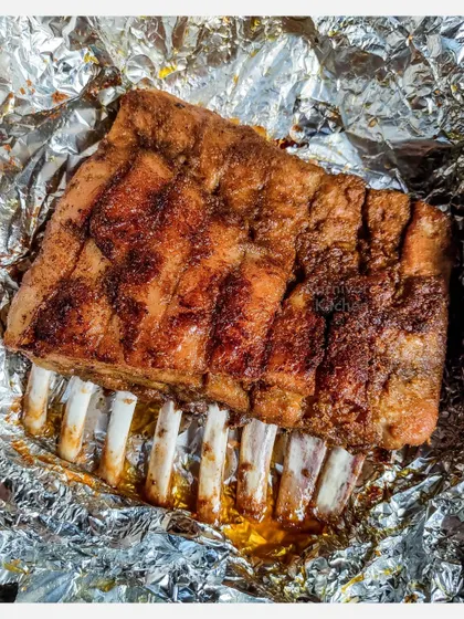 A full rack of my Grilled Pork Spare Ribs, fresh off the grill. I marinate them overnight and slow-grill them for six hours until the meat is fall-off-the-bone tender.