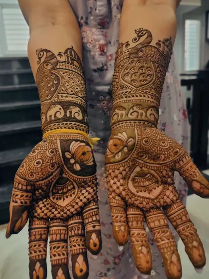 A matching design for the bride's mother, filled with peacocks, elephants, and lotus flowers.
