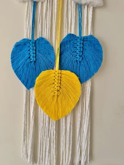 The beautiful blue and yellow macrame leaves add a lovely finishing touch to this custom piece.