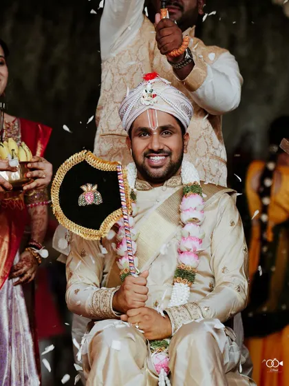 A happy portrait of the groom being carried during a fun wedding ritual.
