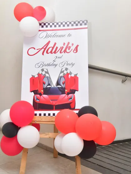 A welcome sign for a race car-themed second birthday party.