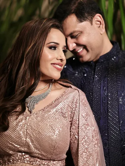 A sweet moment between the couple at their Sangeet. Her makeup is glamorous yet soft, perfect for the occasion.