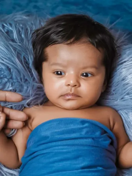 Holding onto mommy and daddy's fingers. This simple pose shows the incredible bond and the tininess of your new baby.