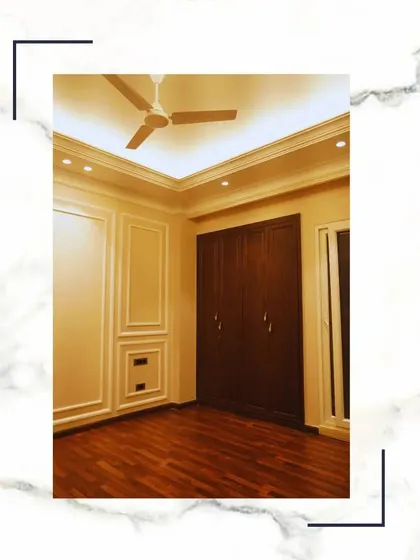 This is the epitome of lavish living. A bedroom with rich wooden floors, classic wall moulding, and a spacious wardrobe, designed to be your exclusive retreat.