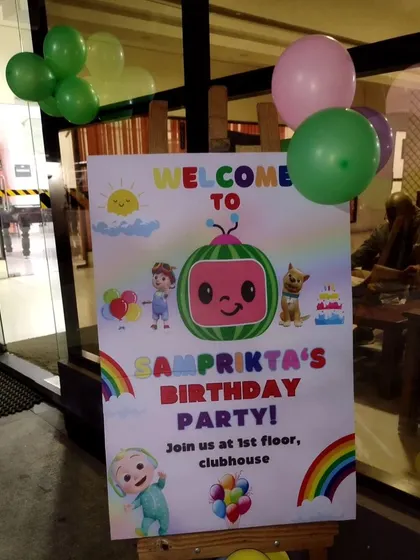 This welcome sign for a Cocomelon birthday party greets guests with colorful graphics and characters from the show.