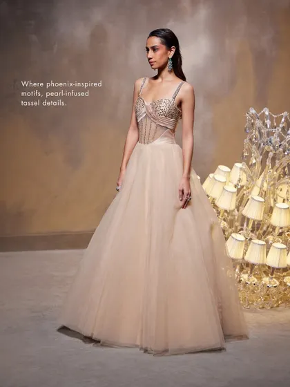 The Bella Gown, where phoenix-inspired motifs and pearl-infused tassel details adorn the exquisite corset, blending artistry with a breathtaking silhouette.