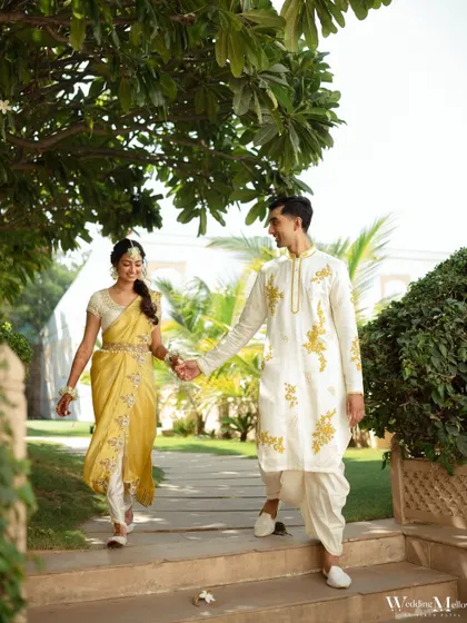 The couple taking a stroll in the gardens of the Radisson Blu Udaipur during their Haldi ceremony. A moment of calm before the fun begins.