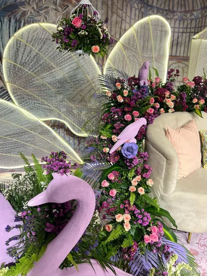 A close-up of the illuminated wings and sculptural props, showcasing the blend of art and light in this unique design.