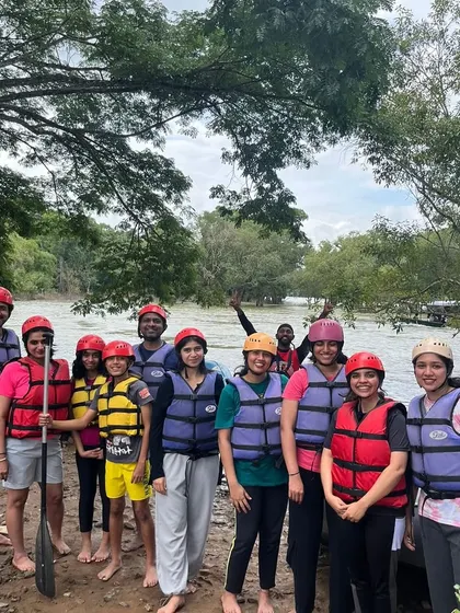 Our group, all geared up with life jackets and helmets, ready for an exciting river rafting session in Coorg.