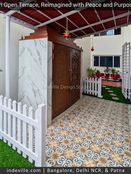 This terrace was reimagined with peace and purpose. The space combines patterned floor tiles, a white picket fence for charm, and a magnificent marble temple structure, blending sacred and leisure areas seamlessly.
