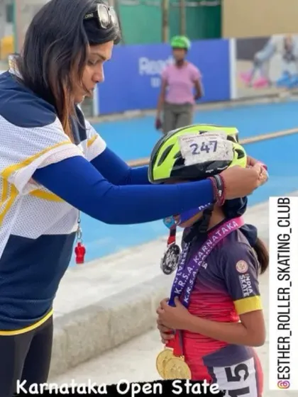 Adjusting a young skater's helmet after her win at the Karnataka Open State championship. These small moments of connection are just as important as the medals.