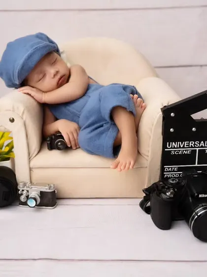 Lights, camera, action! A future director in the making with this fun, movie-themed newborn setup, complete with a tiny clapperboard and cameras.