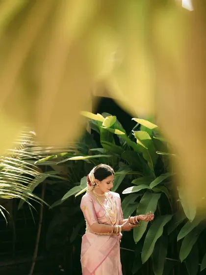 A close-up version of the framed portrait, focusing on the bride adjusting her bangles.