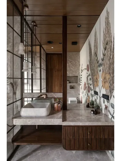 The full vanity view, showcasing the stone sink, wood cabinetry, and the reflection of the floral mural in the mirror.