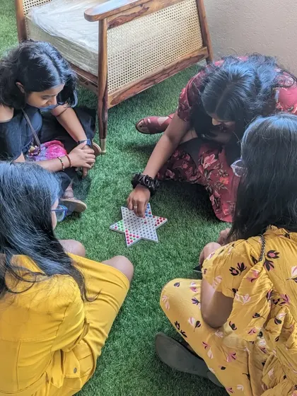 A group of friends enjoying a game of origami together.
