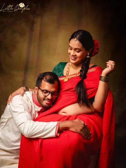 The joy on his face as he listens to the baby bump is priceless. This is a beautiful moment from a traditional couple's maternity shoot in my studio.