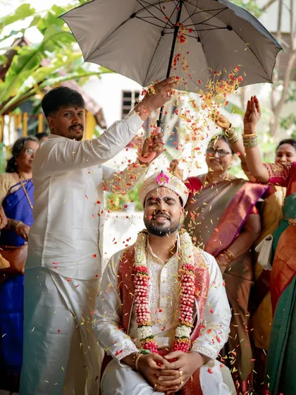A joyful moment during Chirag's Kashi Yatra, as he is showered with flower petals by his family. The happiness on his face is infectious.