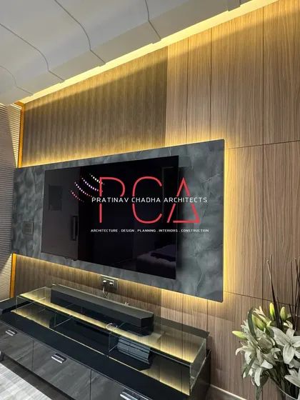 An alternate view of the TV unit in the son's room, showing the full wall composition and the elegant floral arrangement.